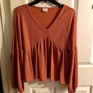 Peach love peplum rust long sleeve top